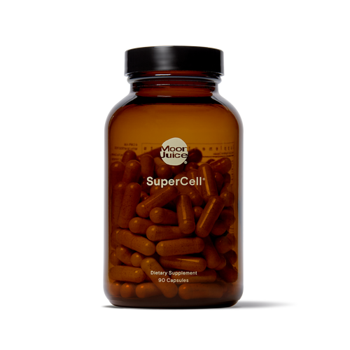 An amber glass supplement bottle with a black cap, filled with brown capsules, labeled 'Moor Juice SuperCell' on a clean white background.