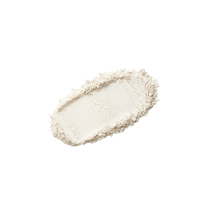 A textured smear of off-white cosmetic powder, likely a face powder or loose setting powder, shown on a solid white background.